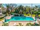 Inviting community pool with lounge chairs and patio tables at 300 S Florida Ave # 400D, Tarpon Springs, FL 34689