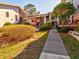 Condo building entrance with walkway and landscaping at 300 S Florida Ave # 400D, Tarpon Springs, FL 34689