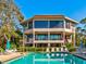 Community pool with patio furniture and lush landscaping at 300 S Florida Ave # 400D, Tarpon Springs, FL 34689