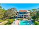 Community pool with lounge chairs and lush landscaping at 300 S Florida Ave # 400D, Tarpon Springs, FL 34689
