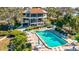 Aerial view of a community pool and building with lush landscaping at 300 S Florida Ave # 400D, Tarpon Springs, FL 34689