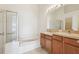 Bathroom with double sinks, soaking tub, and shower at 31447 Shaker Cir, Wesley Chapel, FL 33543