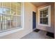House entry with blue door and tiled flooring at 31447 Shaker Cir, Wesley Chapel, FL 33543