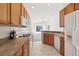 Kitchen with wood cabinets, tiled floor, and appliances at 31447 Shaker Cir, Wesley Chapel, FL 33543