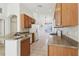 View of kitchen with wood cabinets, granite counters, and appliances at 31447 Shaker Cir, Wesley Chapel, FL 33543