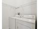 Laundry room with washer, dryer, and shelving at 31447 Shaker Cir, Wesley Chapel, FL 33543