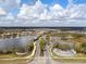 Aerial view of a residential community featuring lakes, lush greenery, and attractive landscaping at 3221 Acacia Bay Dr, Wesley Chapel, FL 33543