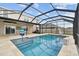 Inviting screened pool with a slide, spacious patio, and ample lounging space at 32664 Pez Landing Ln, Wesley Chapel, FL 33543