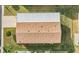 Aerial view of a house with brown shingled roof and a metal covered carport at 37539 Gill Ave, Zephyrhills, FL 33541