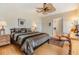 Spacious main bedroom with ceiling fan, ensuite bathroom, and ample closet space at 37539 Gill Ave, Zephyrhills, FL 33541