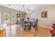 Dining room with hardwood floors and a wood table with green chairs at 37539 Gill Ave, Zephyrhills, FL 33541