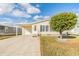 Inviting exterior of a single-story home with a carport and manicured lawn at 37539 Gill Ave, Zephyrhills, FL 33541