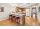 Kitchen with light wood cabinets, white appliances, and a breakfast bar at 37539 Gill Ave, Zephyrhills, FL 33541