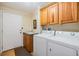 Laundry room with washer, dryer, cabinets, and utility sink at 37539 Gill Ave, Zephyrhills, FL 33541