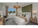Bright main bedroom with king bed, neutral decor, and large window at 4177 Feldspar Ln, Spring Hill, FL 34609