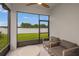 Relaxing screened porch overlooking a grassy backyard with a white fence at 4177 Feldspar Ln, Spring Hill, FL 34609