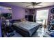 Purple bedroom with a double bed and large window at 4236 Sheldon Pl # B, New Port Richey, FL 34652