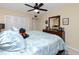 Spacious bedroom with king-size bed and ceiling fan at 5728 14Th N Ave # 305B, St Petersburg, FL 33710