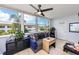 Bright sunroom features a comfy couch, ceiling fan, and ample natural light at 5728 14Th N Ave # 305B, St Petersburg, FL 33710