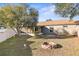 Landscaped backyard featuring a firepit and shed at 6515 Clair Shore Dr, Apollo Beach, FL 33572
