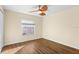 Well-lit bedroom with wood-look floors and ceiling fan at 6515 Clair Shore Dr, Apollo Beach, FL 33572