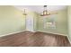 Inviting entryway with wood-look floors and elegant light fixtures at 6515 Clair Shore Dr, Apollo Beach, FL 33572