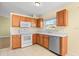 Bright kitchen with oak cabinets, white appliances, and tile flooring at 6515 Clair Shore Dr, Apollo Beach, FL 33572