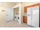 Convenient laundry room with washer, dryer, and shelving at 6515 Clair Shore Dr, Apollo Beach, FL 33572