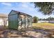 Green storage shed in backyard near water at 6515 Clair Shore Dr, Apollo Beach, FL 33572