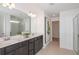 Bathroom with double vanity, dark wood cabinets, and walk-in shower at 6659 Depue Dr, Wesley Chapel, FL 33545