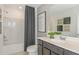 Clean bathroom with a dark vanity, bathtub, and shower at 6659 Depue Dr, Wesley Chapel, FL 33545