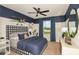 Stylish bedroom with navy and white decor, comfortable bedding, and plenty of light at 6659 Depue Dr, Wesley Chapel, FL 33545