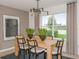 Bright dining room with wood table, chairs, and lake view at 6659 Depue Dr, Wesley Chapel, FL 33545