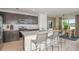 Open kitchen with island, stainless steel appliances, and dining area at 6659 Depue Dr, Wesley Chapel, FL 33545