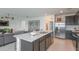 Kitchen island with white countertop and dark wood cabinets at 6659 Depue Dr, Wesley Chapel, FL 33545