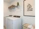Bright laundry room with washer, dryer, and shelving at 6659 Depue Dr, Wesley Chapel, FL 33545