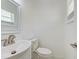 Clean bathroom with white vanity, toilet, and window at 6703 N 30Th St, Tampa, FL 33610