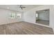 Open living room with wood-look floors and ceiling fan at 6703 N 30Th St, Tampa, FL 33610