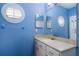 Small bathroom with single vanity and light blue walls at 9244 Rhea Dr, Odessa, FL 33556
