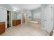 Main bathroom with soaking tub, shower, and double vanity at 9244 Rhea Dr, Odessa, FL 33556