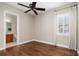 Bedroom with hardwood floors, window, and an en-suite bathroom at 9244 Rhea Dr, Odessa, FL 33556
