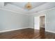 Light and airy bedroom with hardwood floors and an open doorway at 9244 Rhea Dr, Odessa, FL 33556