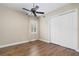Bedroom featuring hardwood floors, ceiling fan, closet, and a window at 9244 Rhea Dr, Odessa, FL 33556