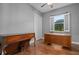 Home office or bedroom with hardwood floors and built-ins at 9244 Rhea Dr, Odessa, FL 33556