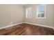 Cozy room with hardwood floors and natural light from shuttered windows at 9244 Rhea Dr, Odessa, FL 33556