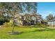 Stunning two-story home with manicured lawn and mature trees at 9244 Rhea Dr, Odessa, FL 33556