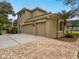 Two-story house with three-car garage and paved driveway at 9244 Rhea Dr, Odessa, FL 33556