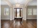 Elegant foyer with hardwood floors, chandelier, and wood door at 9244 Rhea Dr, Odessa, FL 33556