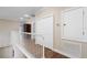 Second floor hallway with hardwood floors, white railings, and a closet at 9244 Rhea Dr, Odessa, FL 33556