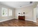Neutral living room with hardwood floors, shutters, and antique cabinet at 9244 Rhea Dr, Odessa, FL 33556